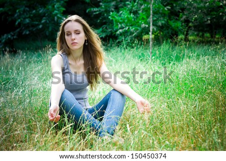 meditation of young pretty woman in a forest