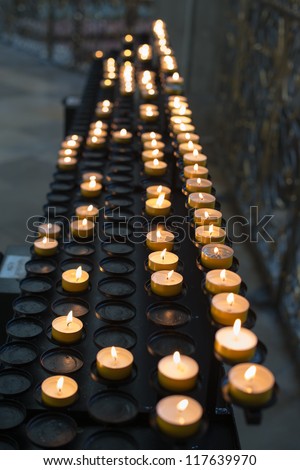 Prayer candles aka offering, sacrificial or memorial candles lit in a church
