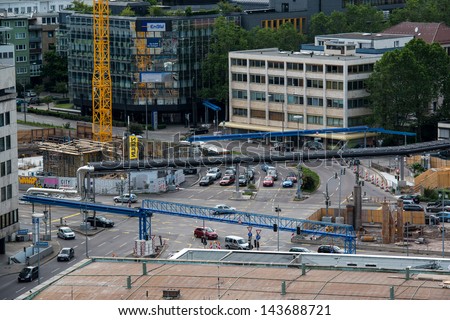 STUTTGART, GERMANY - June 15, 2013: Traffic around construction site at Stuttgart main station (part of S21 project) with long-distance plumbing moved over ground on June 15, 2013 in Stuttgart,Germany
