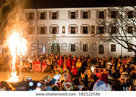 NEUHAUSEN, GERMANY -?? MARCH 4, 2014: Masked people are celebrating the end of carnival season by burning a puppet wearing a traditional costume on March 4, 2014 in Neuhausen (near Stuttgart), Germany