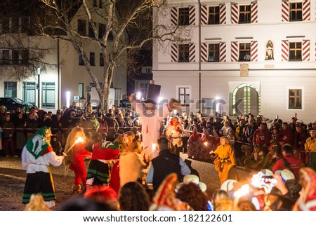 NEUHAUSEN, GERMANY -?? MARCH 4, 2014: Masked people are celebrating the end of carnival season by burning a puppet wearing a traditional costume on March 4, 2014 in Neuhausen (near Stuttgart), Germany