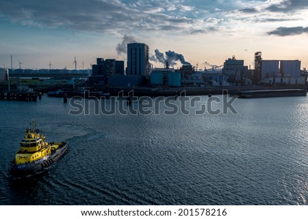 ROTTERDAM, NETHERLANDS - MAY 30, 2014: A tugboat is approaching the viewer in the port of Rotterdam on May 30, 2014 in Rotterdam, the Netherlands. With about 105 square kilometres and a stretch of