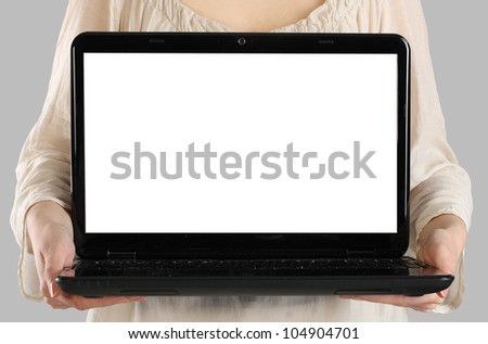 Woman holding a laptop with blank screen