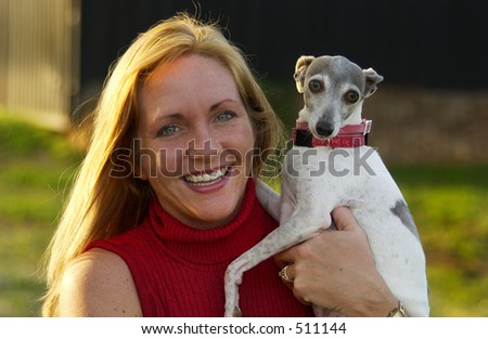 Woman Holding Dog at Sunset