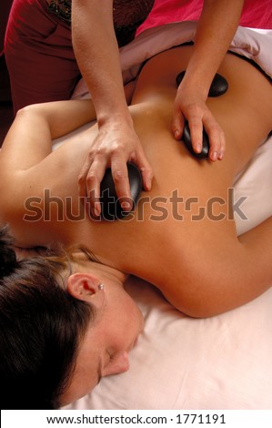 Massage Hot Mineral Stones On Upper Back and Spine