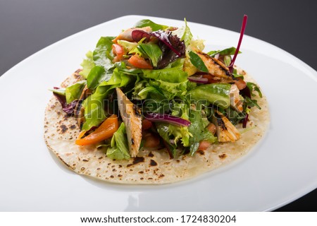 Similar – Image, Stock Photo Grilled spinach fajitas served with cottage cheese and sauce