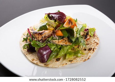 Similar – Image, Stock Photo Grilled spinach fajitas served with cottage cheese and sauce