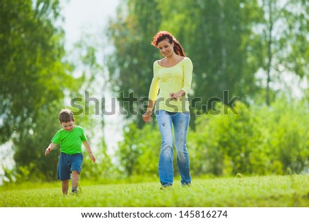 mother and child running across the field