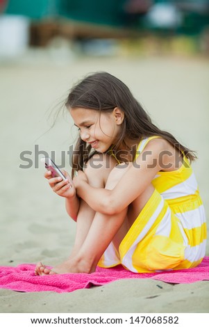 five-year-old girl with a cell phone