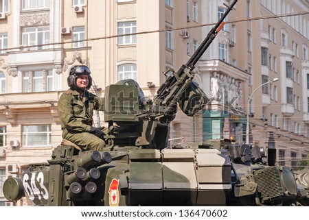 MOSCOW/RUSSIA - MAY 9: Russian officer sits on 2S19 Msta-S howitzer top near anti-aircraft gun on parade festivities devoted to 65th anniversary of Victory Day on May 9, 2010 in Moscow.
