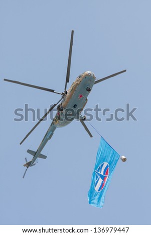MOSCOW/RUSSIA - MAY 9: Mil Mi-8 (Hip) medium transport helicopter with Russian Space Forces flag flies during parade festivities devoted to 65th anniversary of Victory Day on May 9, 2010 in Moscow.