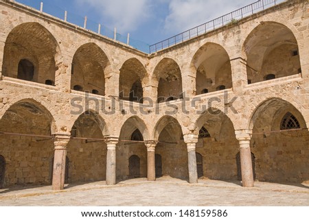 Arched gallery of Khan al-Umdan viewed from paved courtyard. Old city of Acre, Israel.