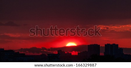 Beautiful sunset with bright Sun over skyline. Moscow, Russia.