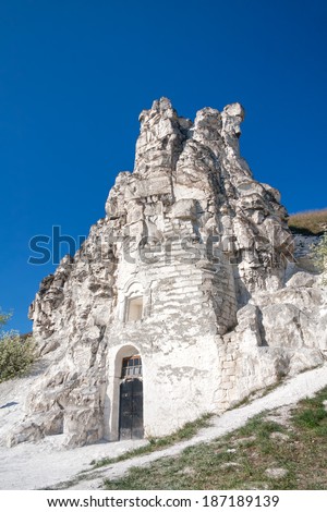 The Icon of the Virgin Mary of Sicilia cave-temple in downs against blue sky background. Divnogorye village, Voronezhsky region, Russia.