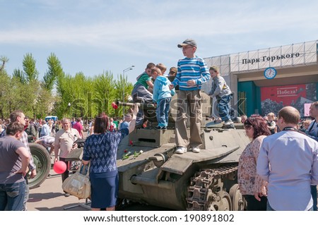 MOSCOW/RUSSIA - MAY 9: Children play on restored BT-5 cavalry tank in Gorky Park during festivities devoted to Victory Day on May 9, 2013 in Moscow.