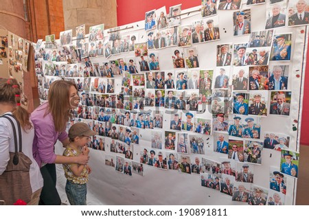 MOSCOW/RUSSIA - MAY 9: Gorky Park visitors look at veterans of WWII photos made here last year during festivities devoted to Victory Day on May 9, 2013 in Moscow.