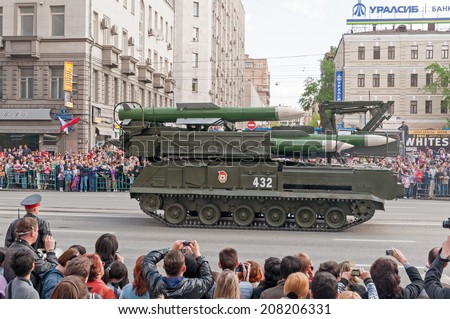 MOSCOW/RUSSIA - MAY 9: People on street side and Russian Army Buk-M2 (SA-11 Gadfly) self-propelled surface-to-air missile system on parade devoted to Victory Day on May 9, 2011 in Moscow.