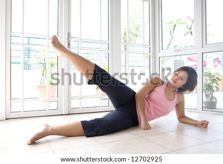 Young female doing leg raises as part of exercise routine