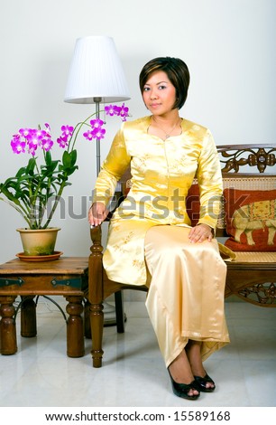 Beautiful Malay woman in traditional kebaya clothing with a modern twist