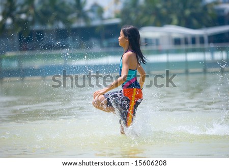 Young girl running through the wading pool at water park