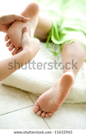Woman receiving foot reflexology.