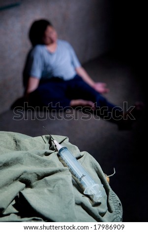 Drug user slumped on the floor after injecting himself.