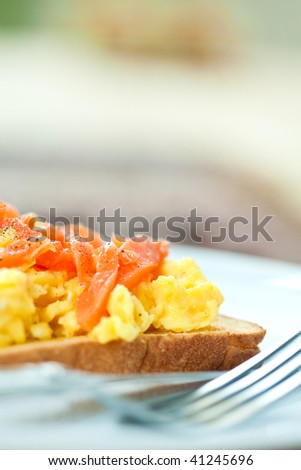 Toast with scrambled eggs and smoke salmon for breakfast
