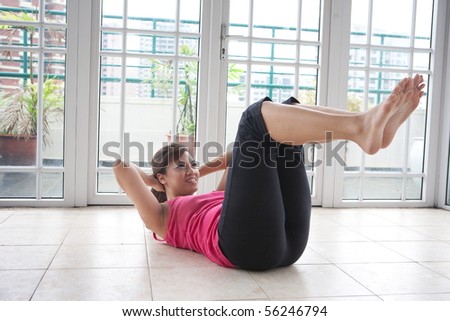Young fitness woman doing her crunching exercise for leaner stomach muscle