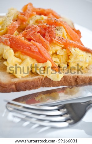 Smoke salmon with scrambled eggs on buttered toast