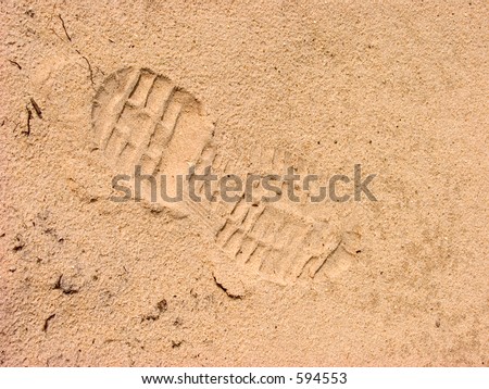 Footprint of shoe  in the sand.