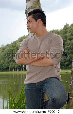 An attractive young man on his lunch hour, taking a rest in the park.