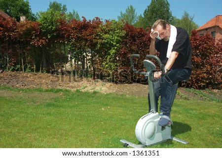 Fitness bicycle for home use. Middle aged man working out, bicycling.
