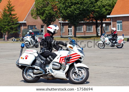 military police intervention.  Officer on bike in pursuit of suspect.  Safety, speed concept.