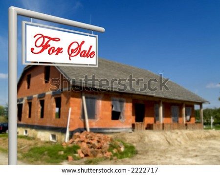 For sale sign in front of house in progress, under construction.  Real estate concept.