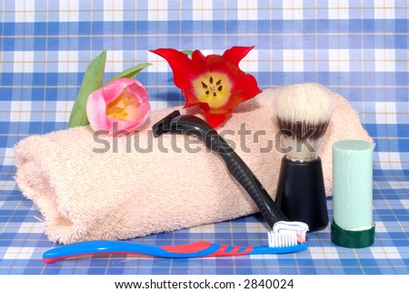 male personal hygiene tools, razor, soap, tooth brush, towel, brush.  Daily routine, grooming concept,
