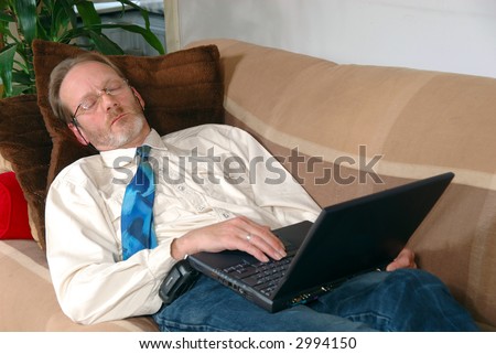 Workaholic, businessman sleeping with laptop on lap. Business, corporate concept.