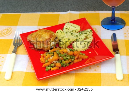 Dinner time, potatoes, peas and carrots stewed with onions and sugar, fried chicken legs. Food nutrition concept.
