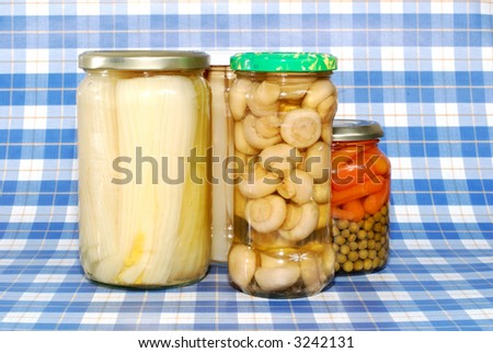 Various canned vegetables, mushrooms, carrots, celery, asparagus in glass pot.  Food, preserve concept.