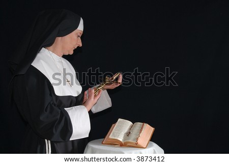 Middle aged devout nun in deep thoughts, praying.  Religion, christianity, lifestyle concept