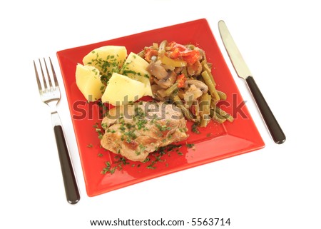 Colorful presentation of gourmet food, grilled Pork Tenderloin, steamed potato and green beans vegetables, garnished with chive