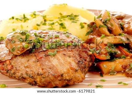 Colorful presentation of gourmet food, Steak Papillon, steamed potato and baked mushrooms for vegetables, garnished with chive