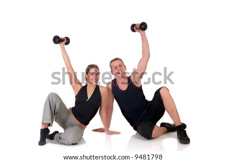 Young couple, attractive female, handsome male doing fitness exercises in the gym. Studio shot