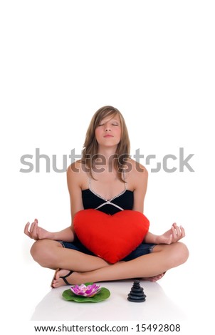 Young attractive girl with Zen stones and lotus flower.   Studio shot, reflective surface