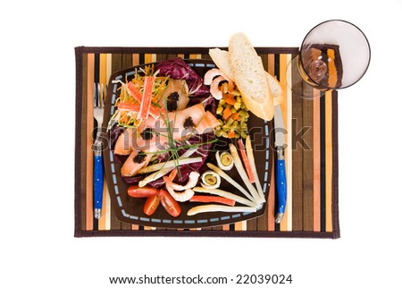 Gourmet smoked salmon dish, garnished with shrimp, caviar, anchovies, olives and vegetables.  Studio shot.