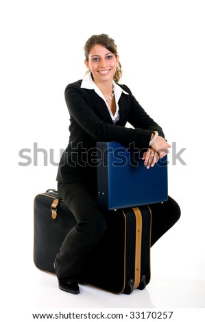 Attractive successful young female sales representative, traveler,  with briefcase and suitcase, studio shot.