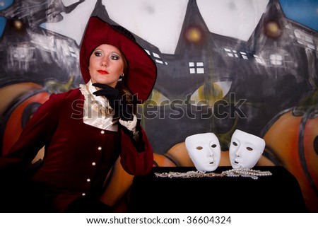 Young woman, Halloween lady with fancy hat. Studio, painted themed background.