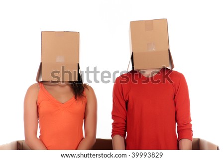 Young couple having quarrel during chat session, chat box, cardboard box representing chat room.  Studio, white background