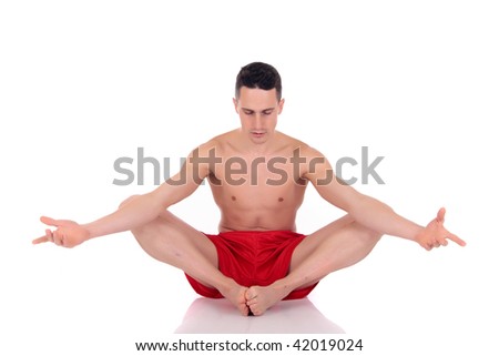 Young handsome male athlete working out on some yoga poses, fitness  Studio shot.