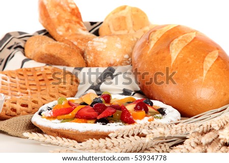 Display of various type of bread and fruit pie.  Studio, white background. Shallow dof, focus on fruit pie