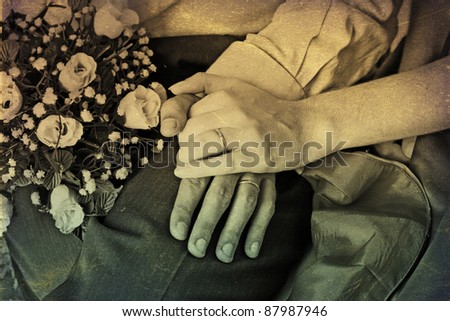 Hands and rings with wedding bouquet, retro texture